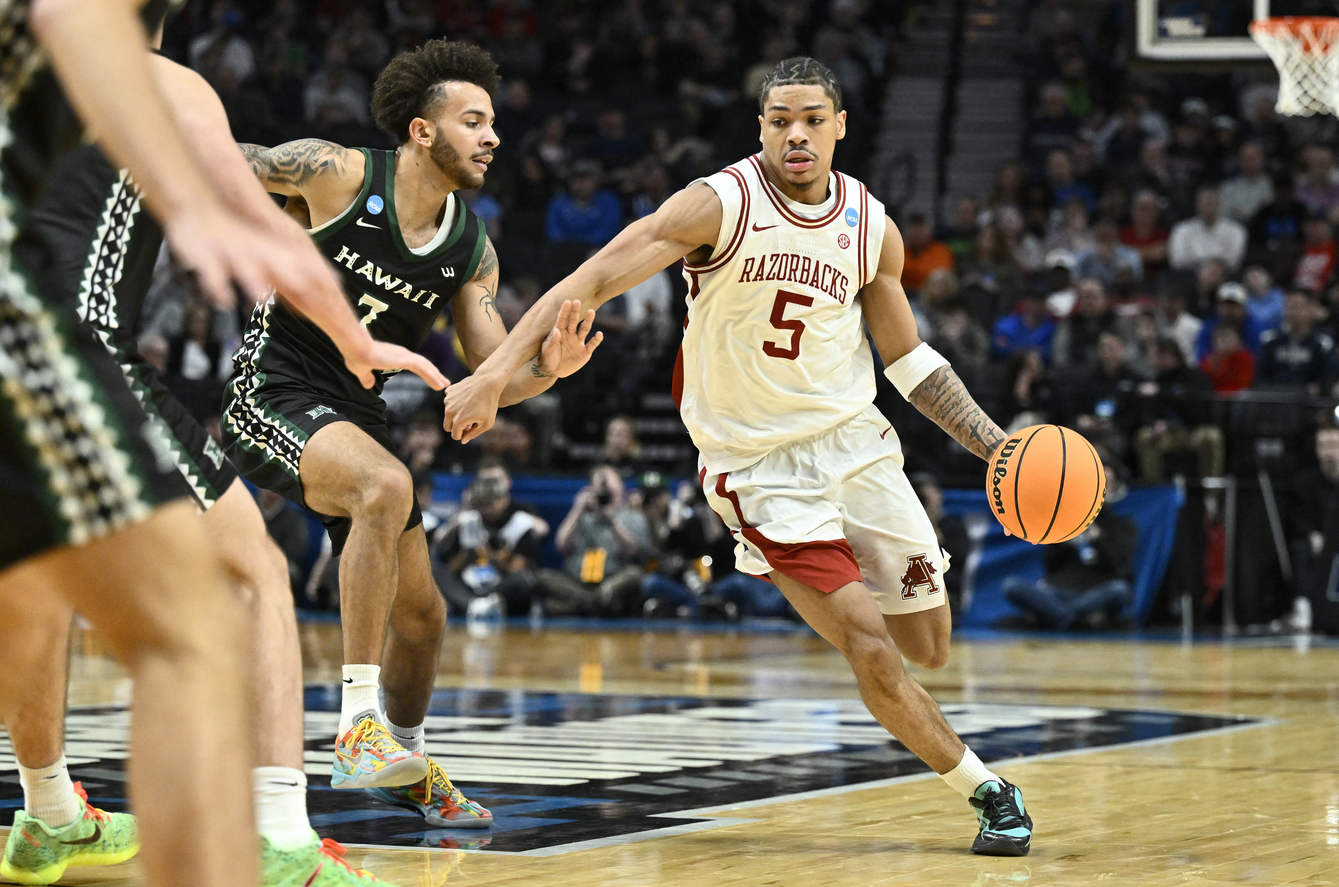 Arkansas' Darius Acuff Jr. (5) leads the Razorbacks in one of eight games covered in our March Madness predictions on Saturday.