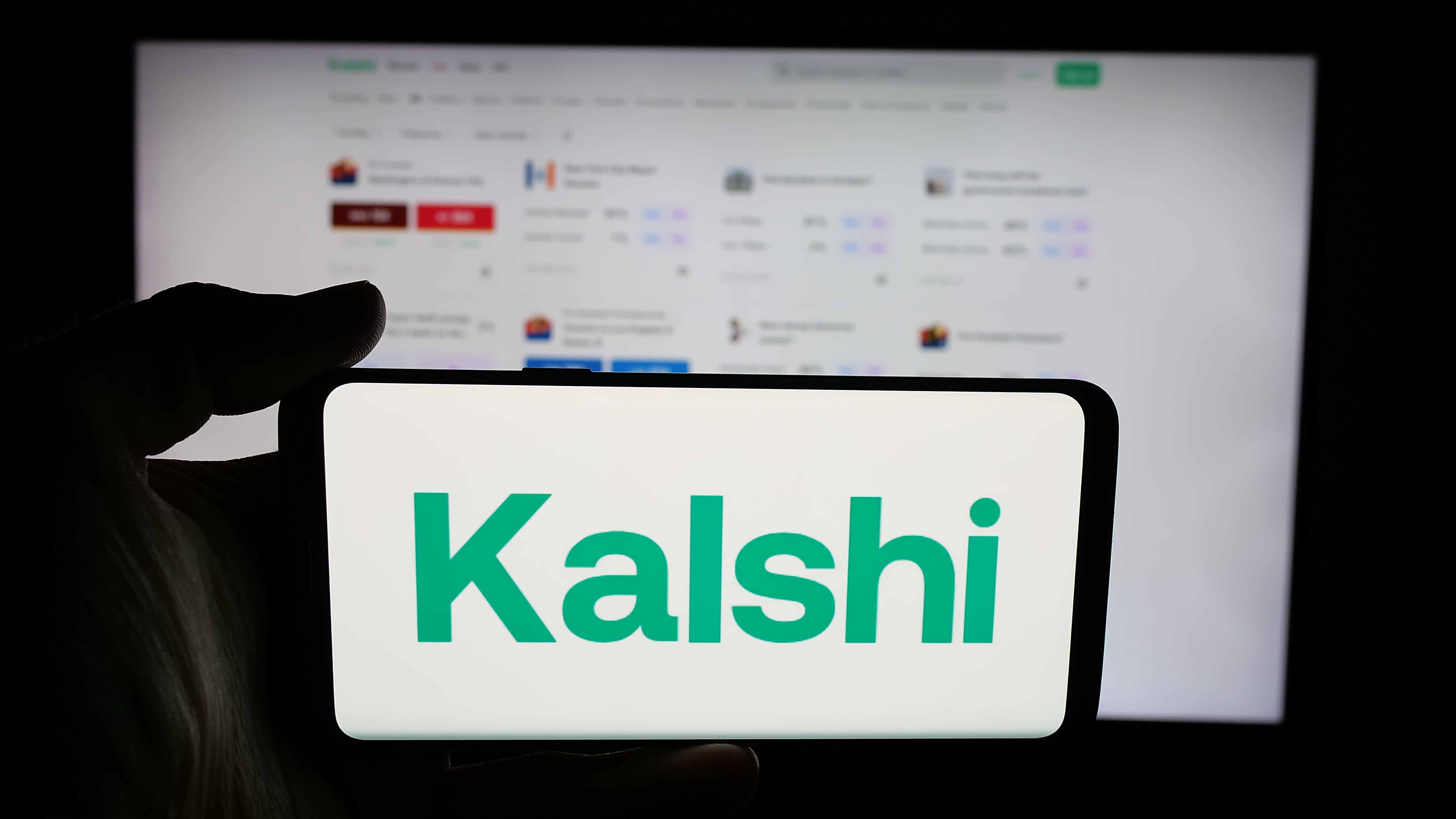 The Kalshi logo is shown on a smartphone as we look at the prediction market's support of legislation to ban insider trading.
