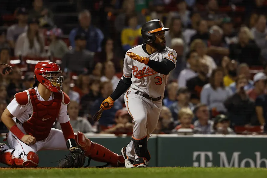 Cedric Mullins of the Baltimore Orioles hits a two-run triple against the Boston Red Sox at Fenway Park on Sept. 26, 2022 in Boston, Massachusetts.