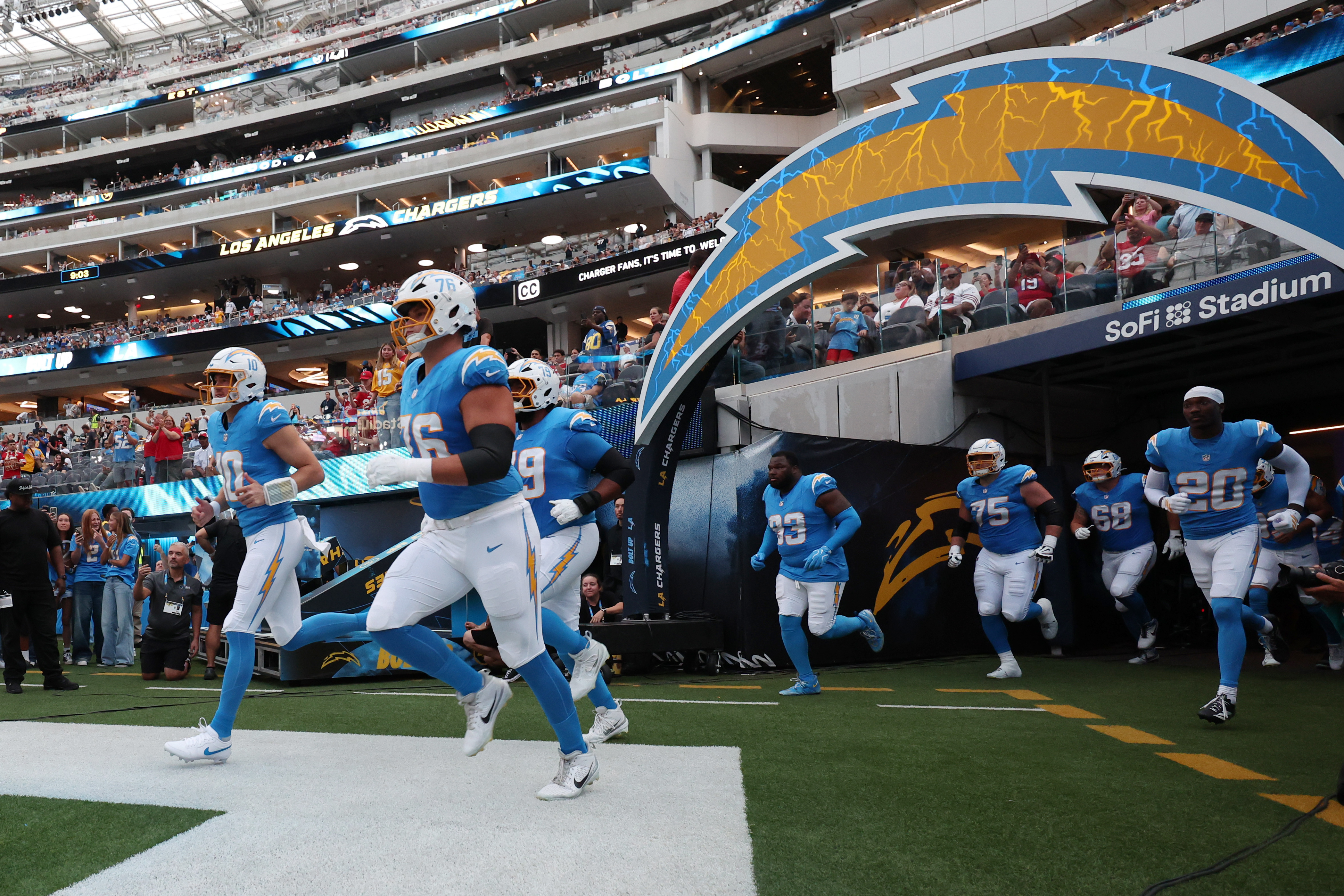 Los Angeles Chargers quarterback Justin Herbert and his teammates run onto the field as we make our best Rams vs. Chargers prediction.