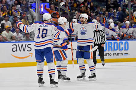 Evan Bouchard (2) of the Edmonton Oilers celebrates with teammates as we offer our best Oilers vs. Stars predictions and expert picks for Game 1 of the Western Conference Final on Thursday at American Airlines Center in Dallas.
