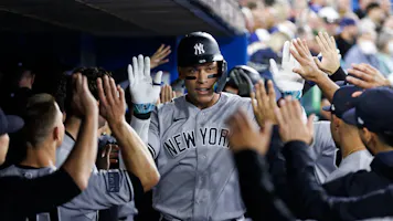 Aaron Judge of the New York Yankees celebrates a two-run homer as we look at our 2024 MLB home run leader odds.
