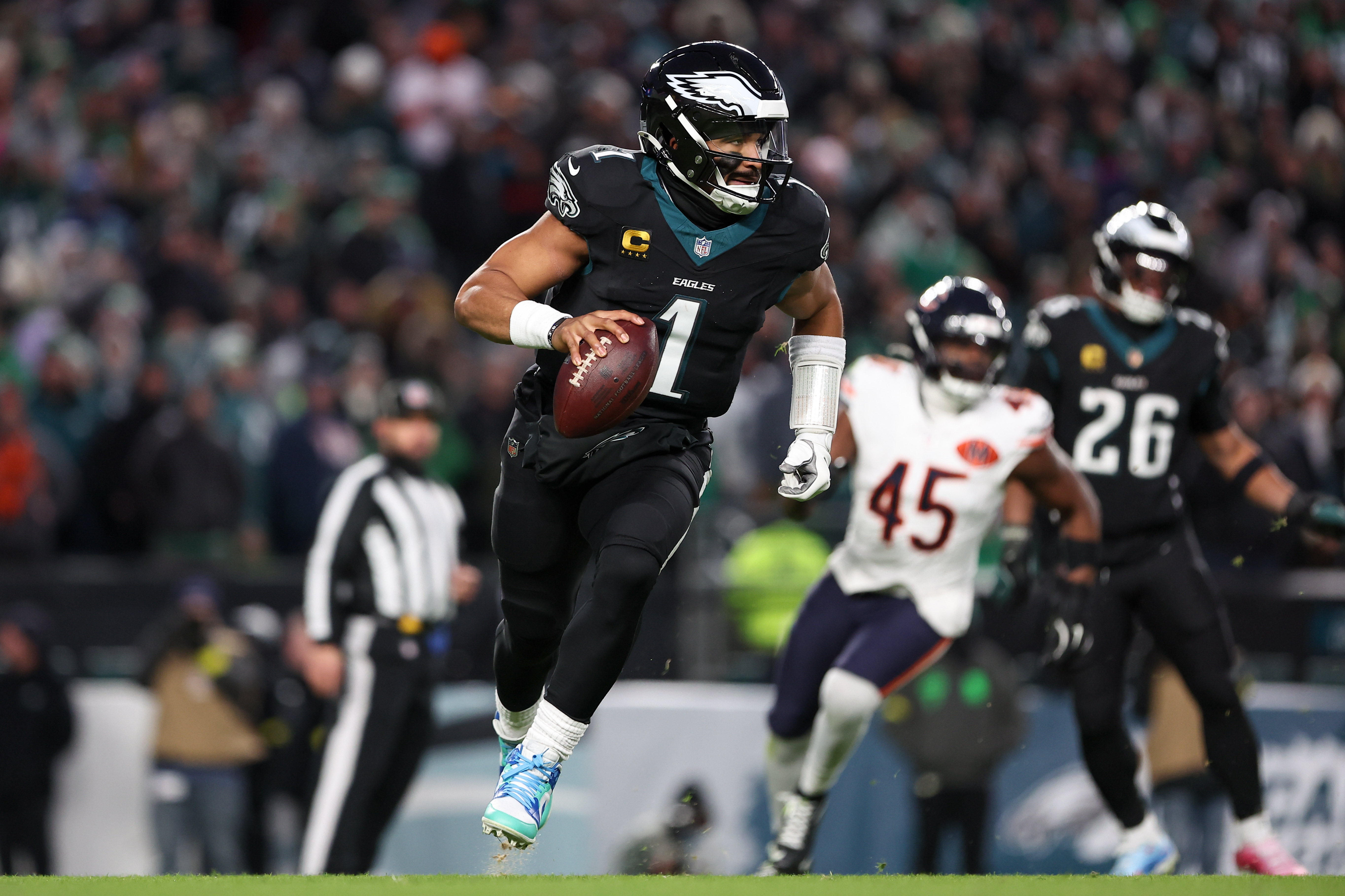 Philadelphia Eagles quarterback Jalen Hurts (1) scrambles against the Chicago Bears as we break down our NFL playoff bracket predictions.