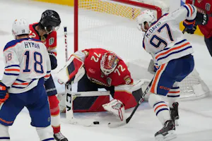 Edmonton Oilers forward Connor McDavid reaches for the puck against Florida Panthers goaltender Sergei Bobrovsky during the third period in Game 1 of the 2024 Stanley Cup Final at Amerant Bank Arena. The Panthers lead the Stanley Cup odds.