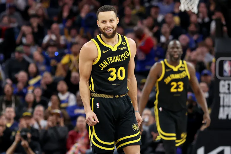 Stephen Curry of the Golden State Warriors smiles while standing on the court during their game against the L.A. Clippers in the first half at Chase Center as we look at our BetRivers promo code for Nuggets-Warriors.