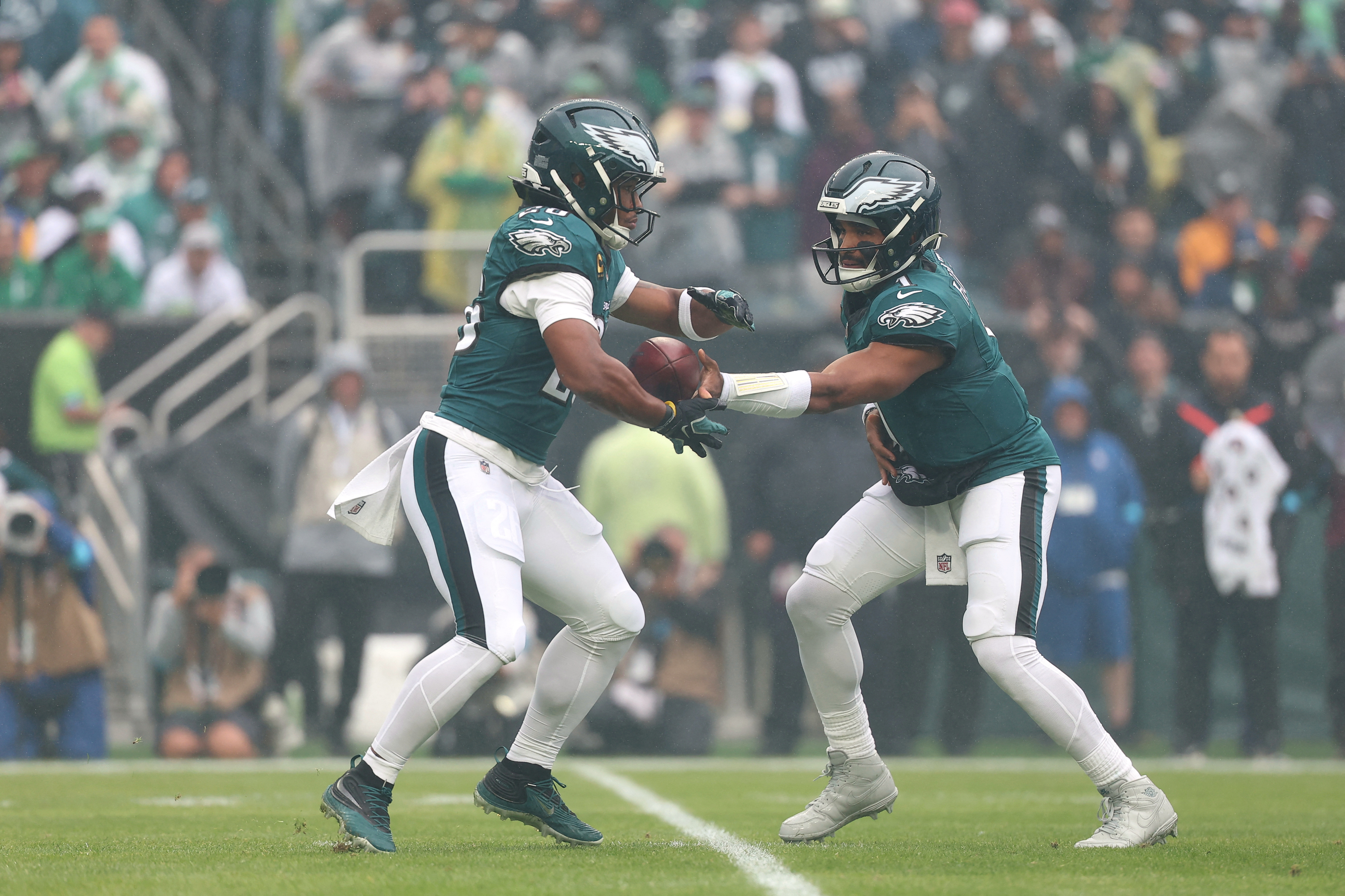 Philadelphia Eagles quarterback Jalen Hurts (1) hands the ball off to running back Saquon Barkley (26) as he is featured in our Cowboys vs. Eagles same-game parlay.