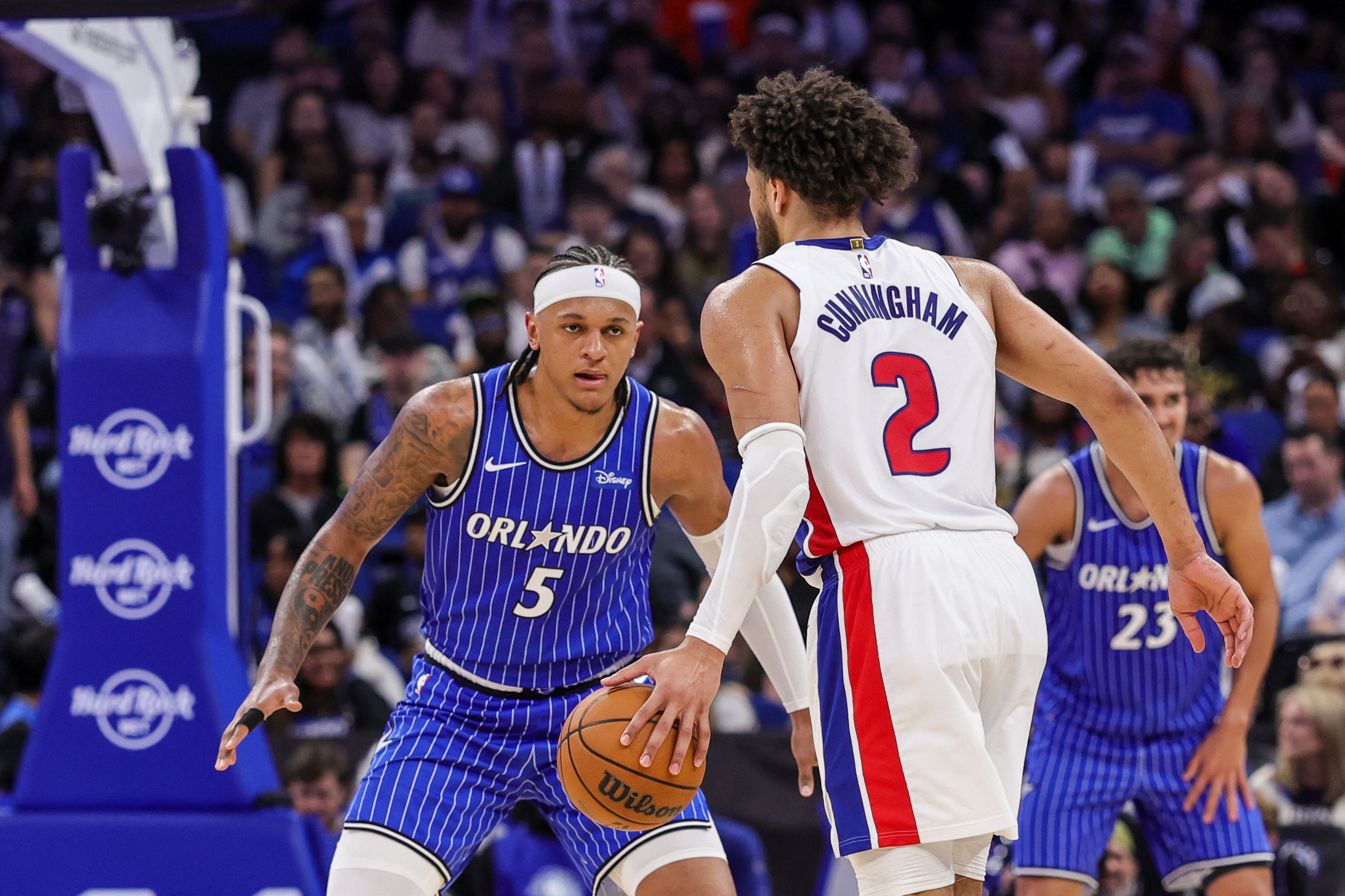 Orlando Magic forward Paolo Banchero (5) defends Detroit Pistons guard Cade Cunningham (2) during the second half at Kia Center.
