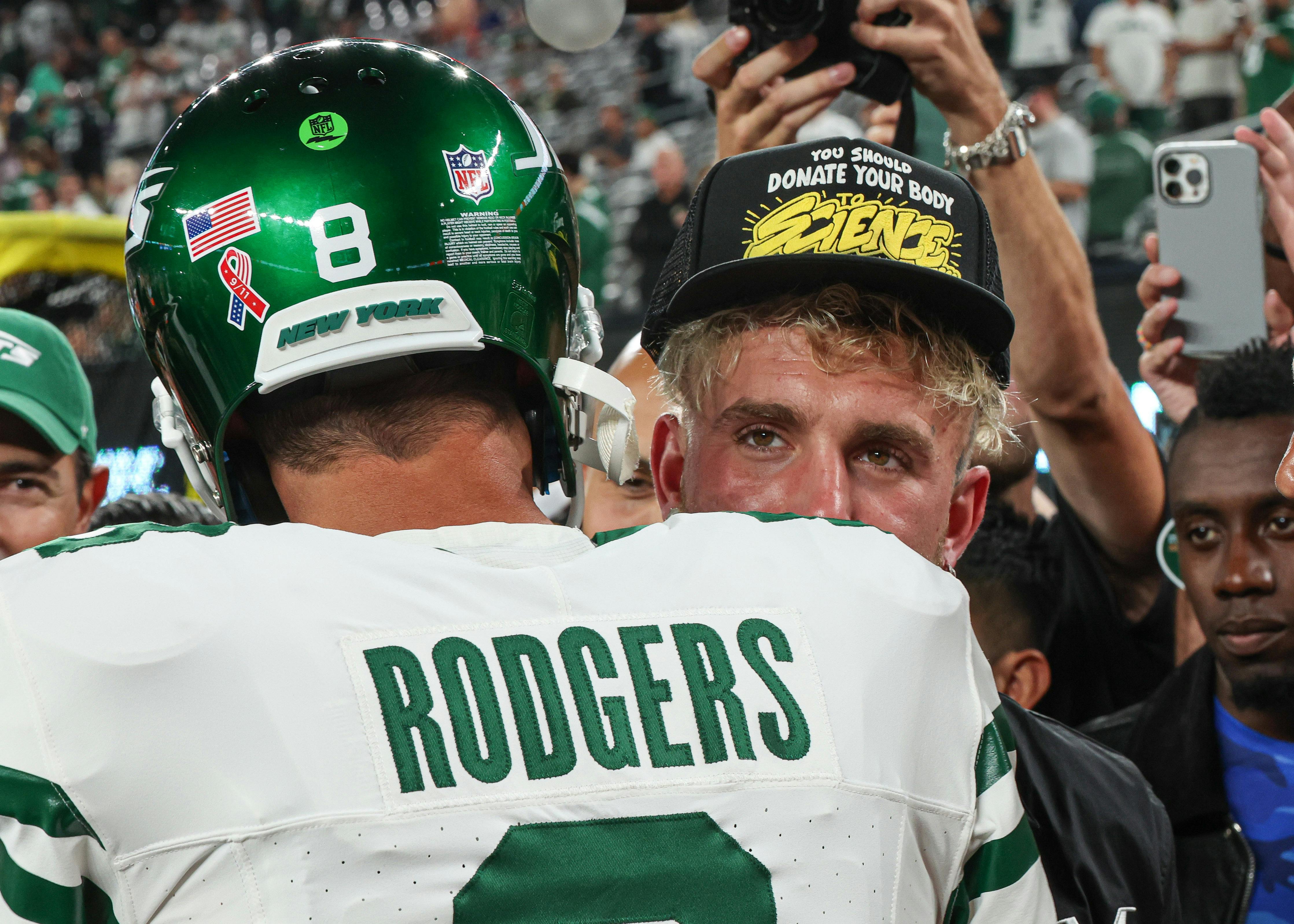 New York Jets quarterback Aaron Rodgers is greeted by social media personality Jake Paul before the game against the Buffalo Bills at MetLife Stadium.