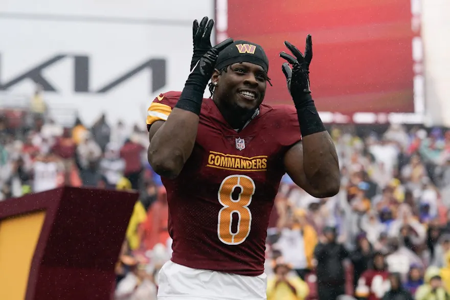 Brian Robinson Jr. of the Washington Commanders runs onto the field before the game against the Buffalo Bills at FedExField as we look at our NFL prop picks for Week 10.
