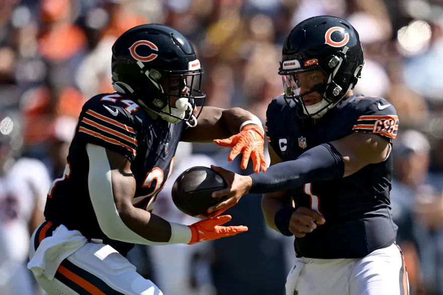 Justin Fields #1 hands the ball off to Khalil Herbert #24 of the Chicago Bears as we look at our Bears - Vikings parlay for Monday Night Football 