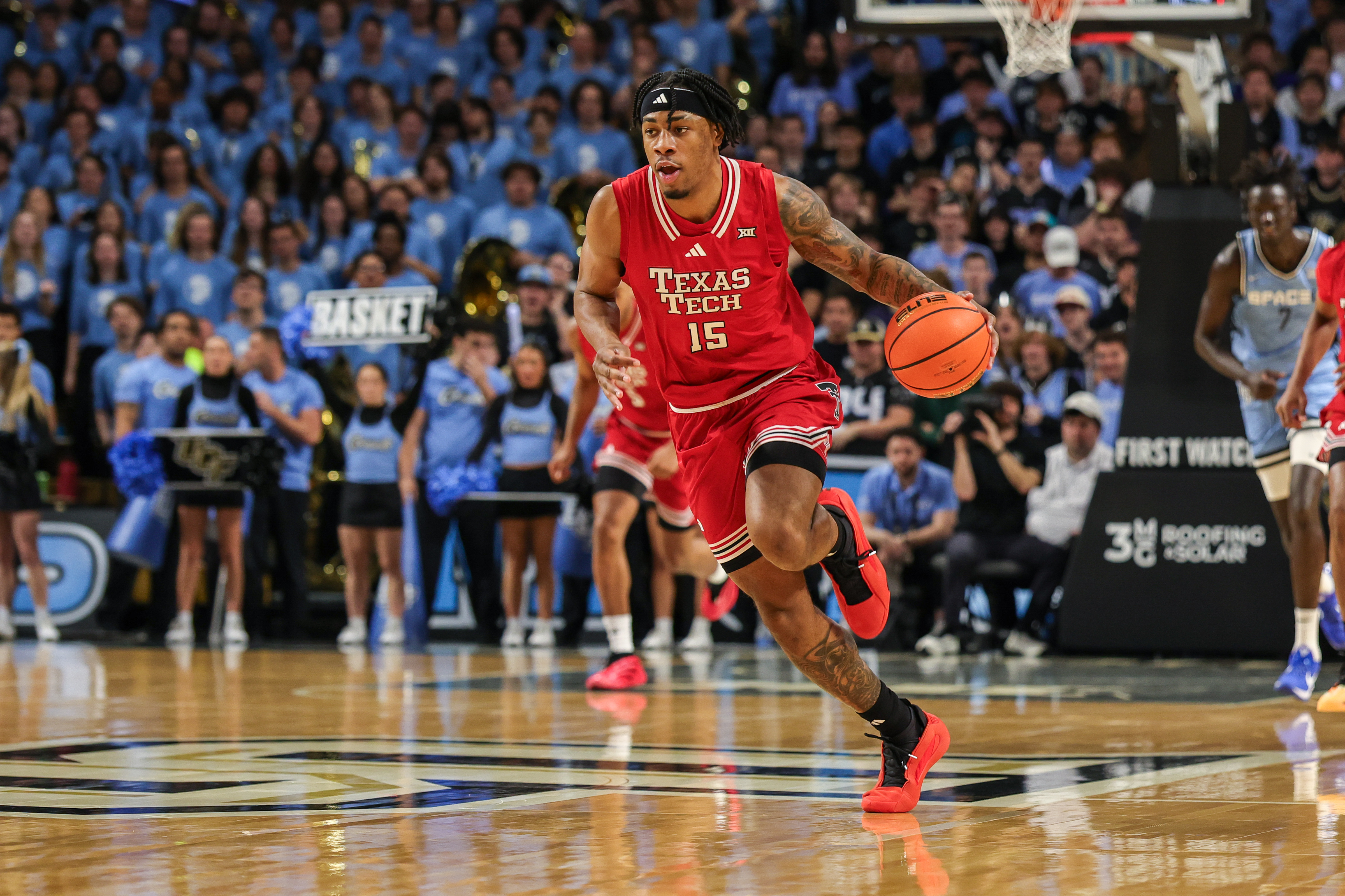 Texas Tech Red Raiders forward JT Toppin brings the ball up court as we make our best Kansas vs. Texas Tech prediction.