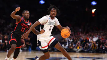 Tristen Newton of the UConn Huskies dribbles against Darrion Trammell of the San Diego State Aztecs during the Sweet 16 round of the NCAA Men's Basketball Tournament. We're backing Newton in our Illinois vs. UConn expert picks and best bet.