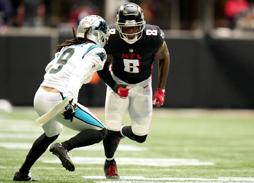 Kyle Pitts of the Atlanta Falcons runs a route while being guarded by Stephon Gilmore of the Carolina Panthers in the first quarter at Mercedes-Benz Stadium on October 31, 2021 in Atlanta, Georgia.