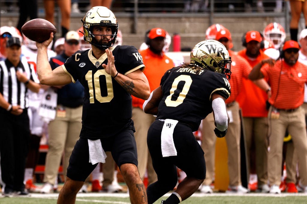 Sam Hartman #10 of the Wake Forest Demon Deacons drops back to pass against the Clemson Tigers during the first half of their game at Truist Field on Sept. 24. Lance King/Getty Images/AFP