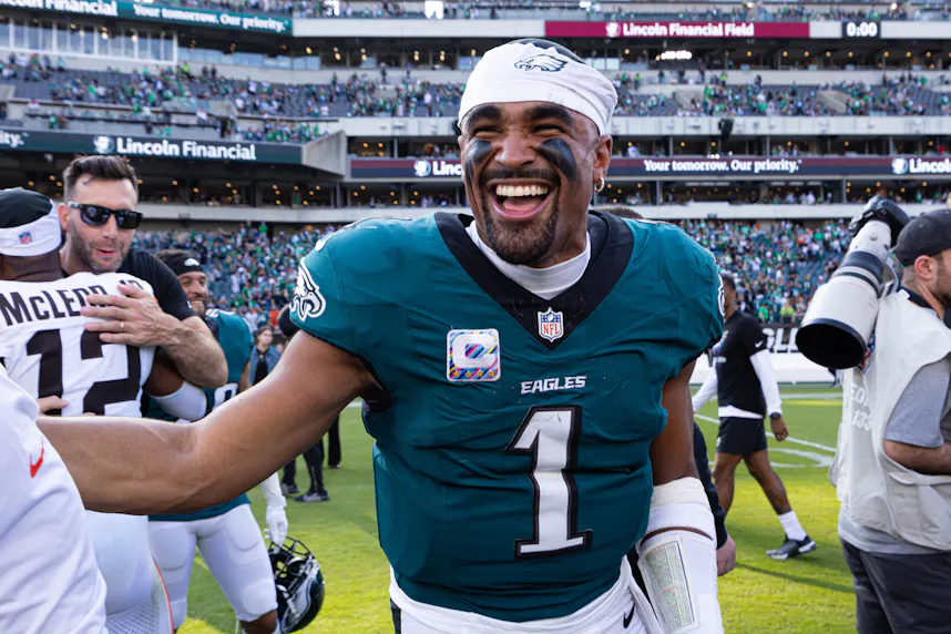 Philadelphia Eagles quarterback Jalen Hurts smiles after a victory against the Cleveland Browns, and we offer our top Eagles vs. Commanders player prop picks.