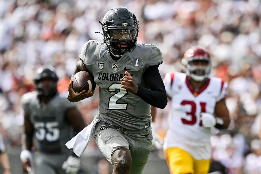 Shedeur Sanders of the Colorado Buffaloes rushes for a touchdown as we look at the early 2024 college football lines.