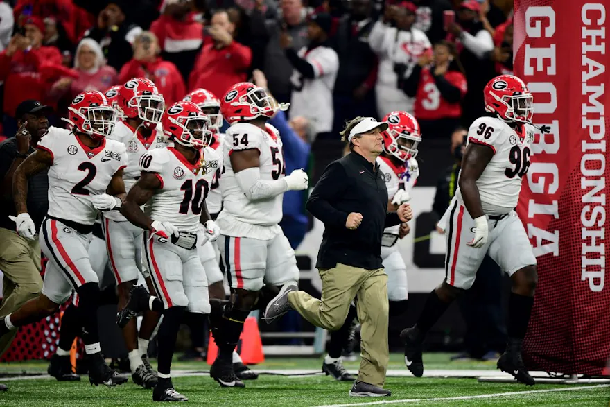 Head Coach Kirby Smart of the Georgia Bulldogs leads players onto the field before facing Alabama in the 2022 CFP National Championship Game at Lucas Oil Stadium in Indianapolis, Indiana. Photo by Emilee Chinn/Getty Images via AFP.