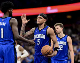 Paolo Banchero (5) of the Orlando Magic high-fives teammate Jonathan Isaac (1) after a play against the Cleveland Cavaliers, as we offer our best Magic vs. Cavaliers player props for Game 7 on Sunday at Rocket Mortgage FieldHouse in Cleveland.