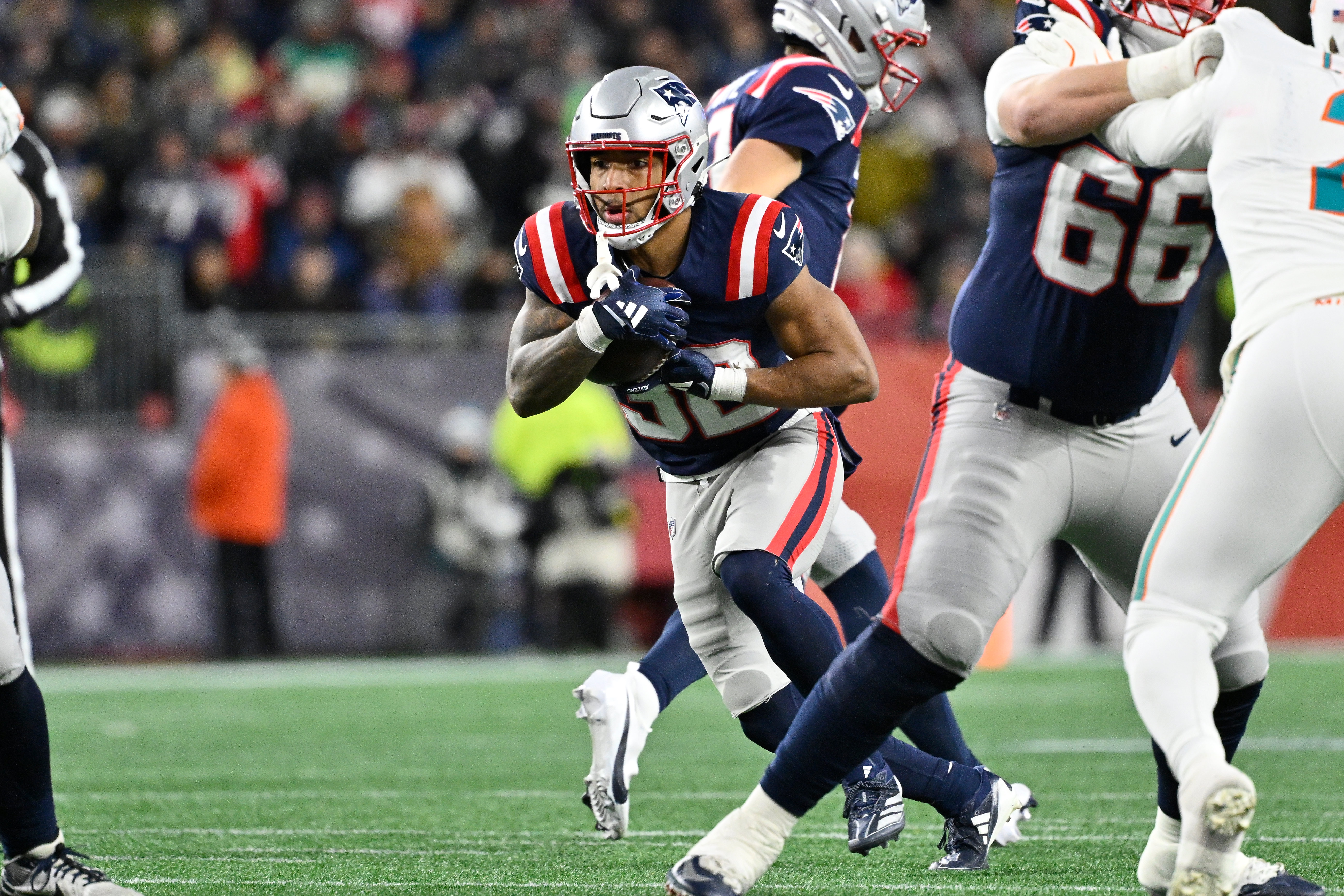 New England Patriots running back Treveyon Henderson (32) runs the ball as we look at the anytime touchdown scorer predictions for Patriots vs. Broncos in the AFC Championship Game