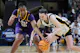 Mikaylah Williams #12 of the LSU Tigers and Caitlin Clark #22 of the Iowa Hawkeyes fight for the ball as we look at the details surrounding how sportsbooks benefitted from the Iowa-LSU Elite Eight game.