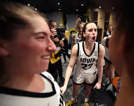 Caitlin Clark #22 of the Iowa Hawkeyes celebrates with the team as we look at our DraftKings promo code for Iowa vs South Carolina