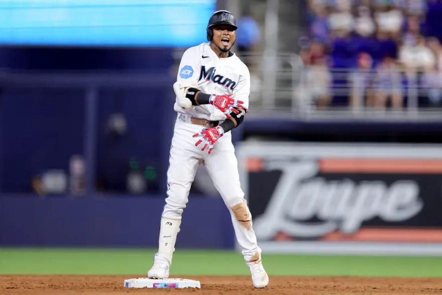 Luis Arraez of the Miami Marlins reacts after hitting an RBI double during the sixth inning against the Colorado Rockies, and we offer our look at the top odds and predictions to lead MLB in hits based on the best MLB odds.