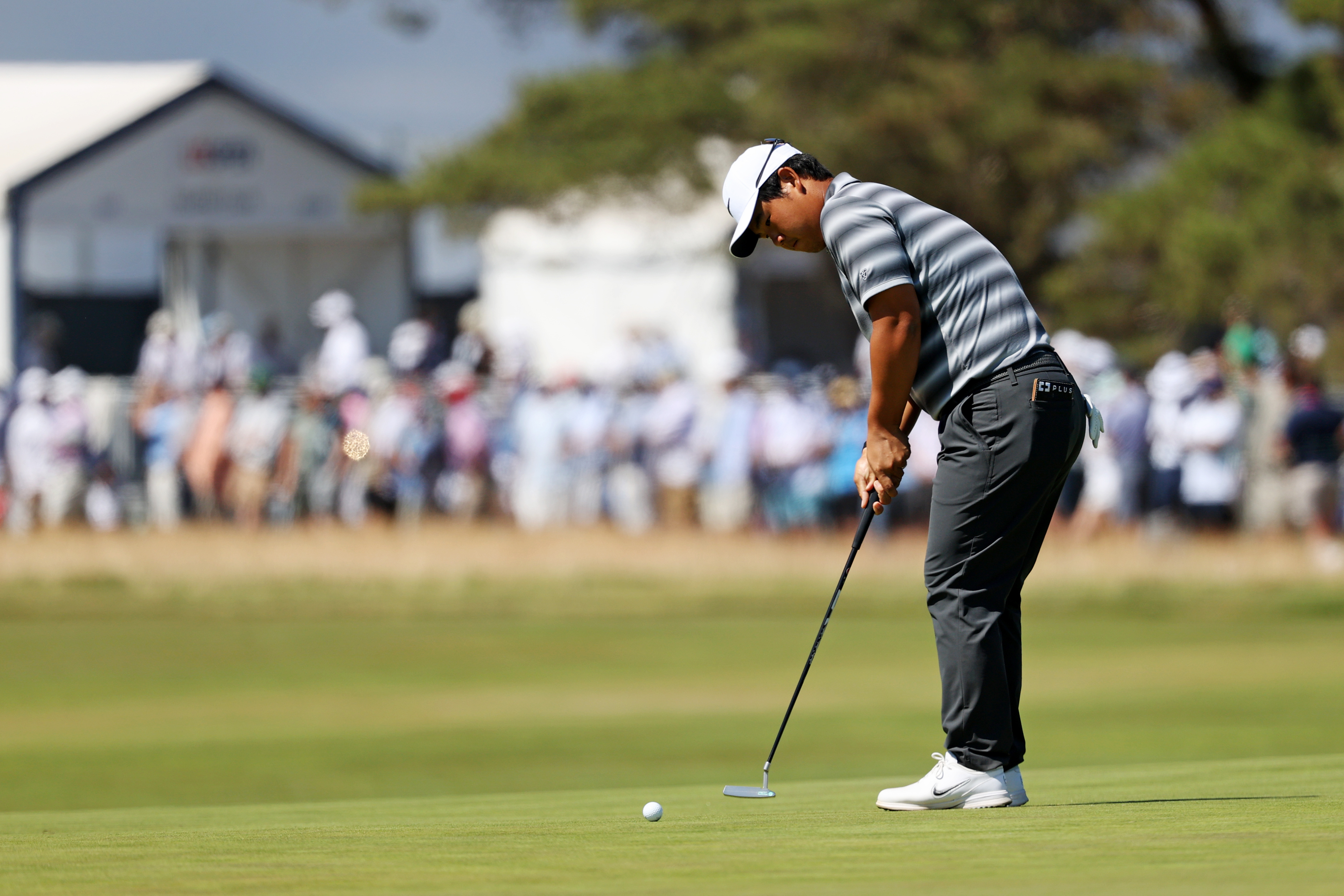 Tom Kim putts on the fourth green as he is featured in our John Deere Classic First-Round Leader prediction & odds.