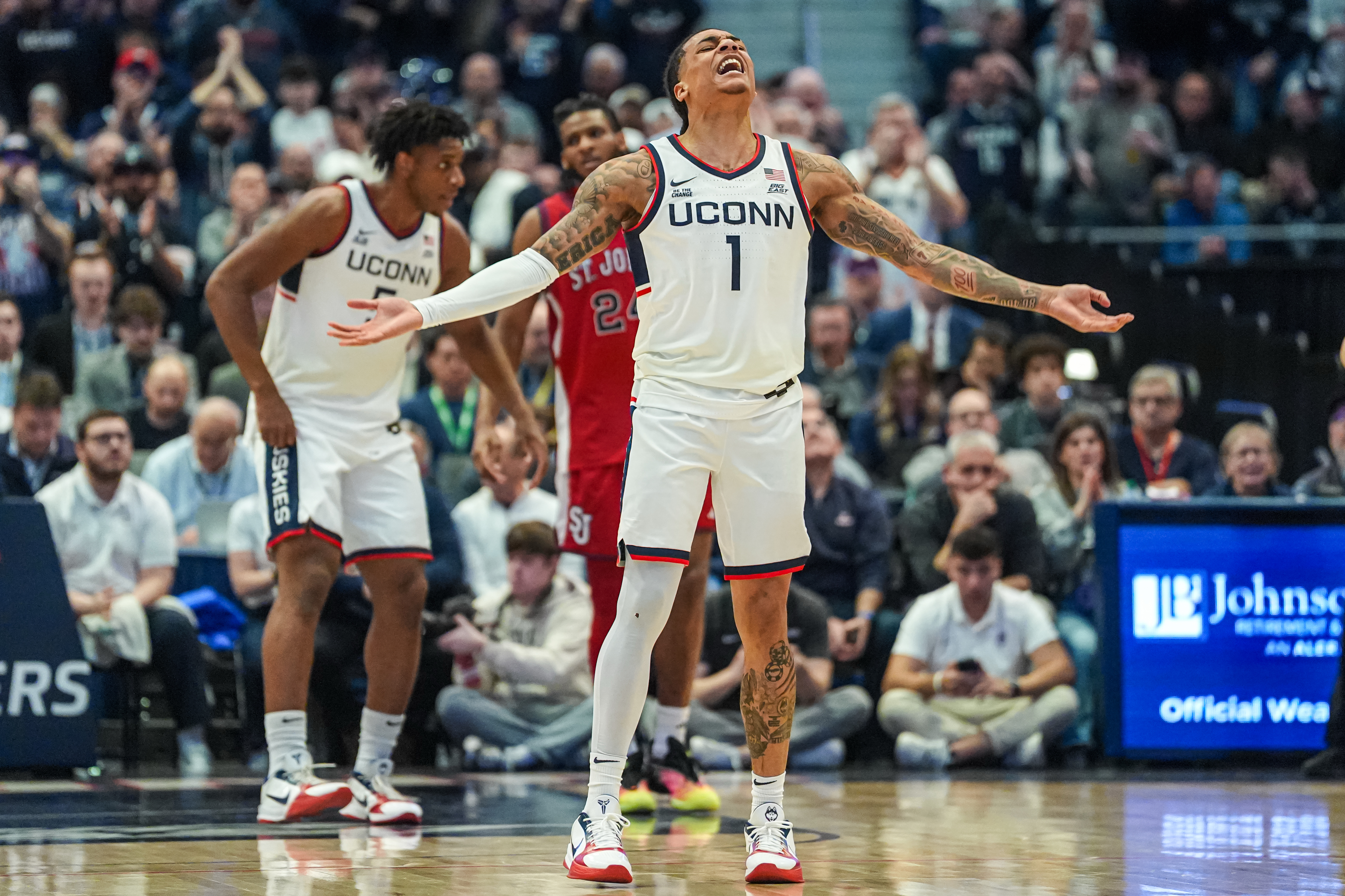 UConn Huskies guard Solo Ball (1) reacts to the crowd as we break down our Georgetown vs. UConn prediction.