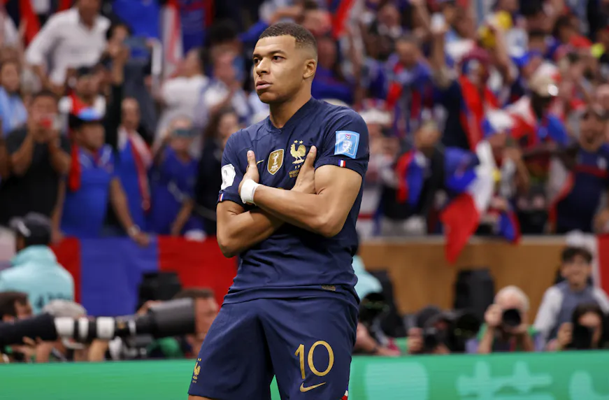 France forward Kylian Mbappe celebrates after scoring a goal against Argentina as we predict the group winners and the teams that will advance into the knockout phase.