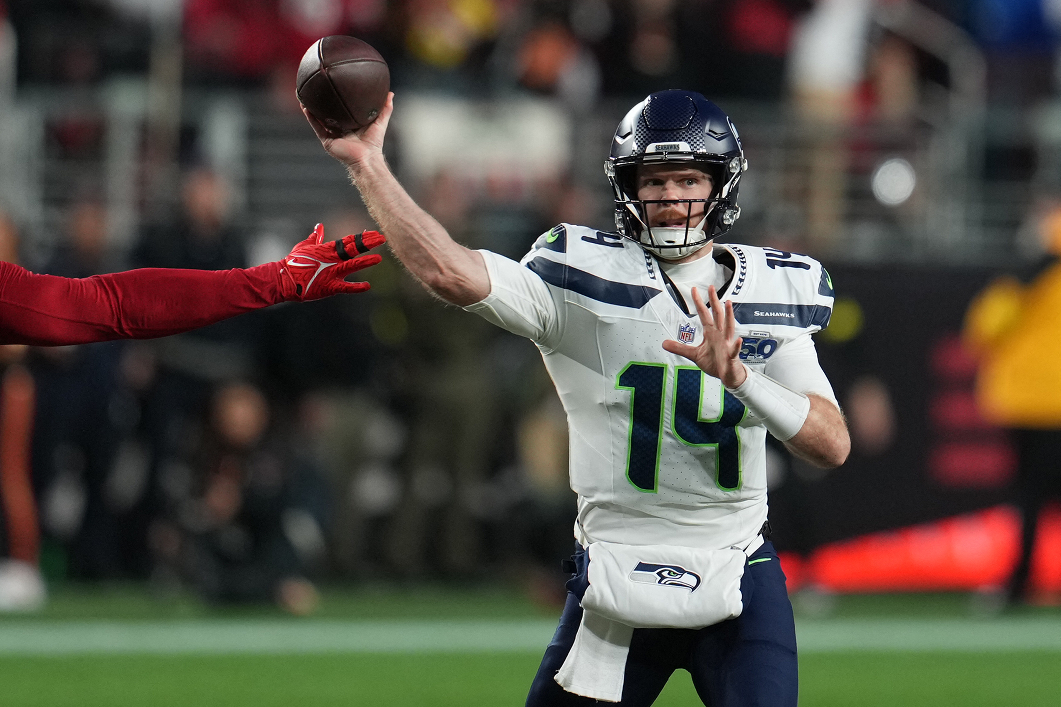 Seattle Seahawks quarterback Sam Darnold (14) drops back to pass as we break down our Sam Darnold injury update.