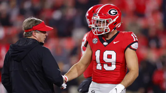 Head coach Kirby Smart of the Georgia Bulldogs speaks with Brock Bowers prior to the game as we share our best Week 14 expert picks.