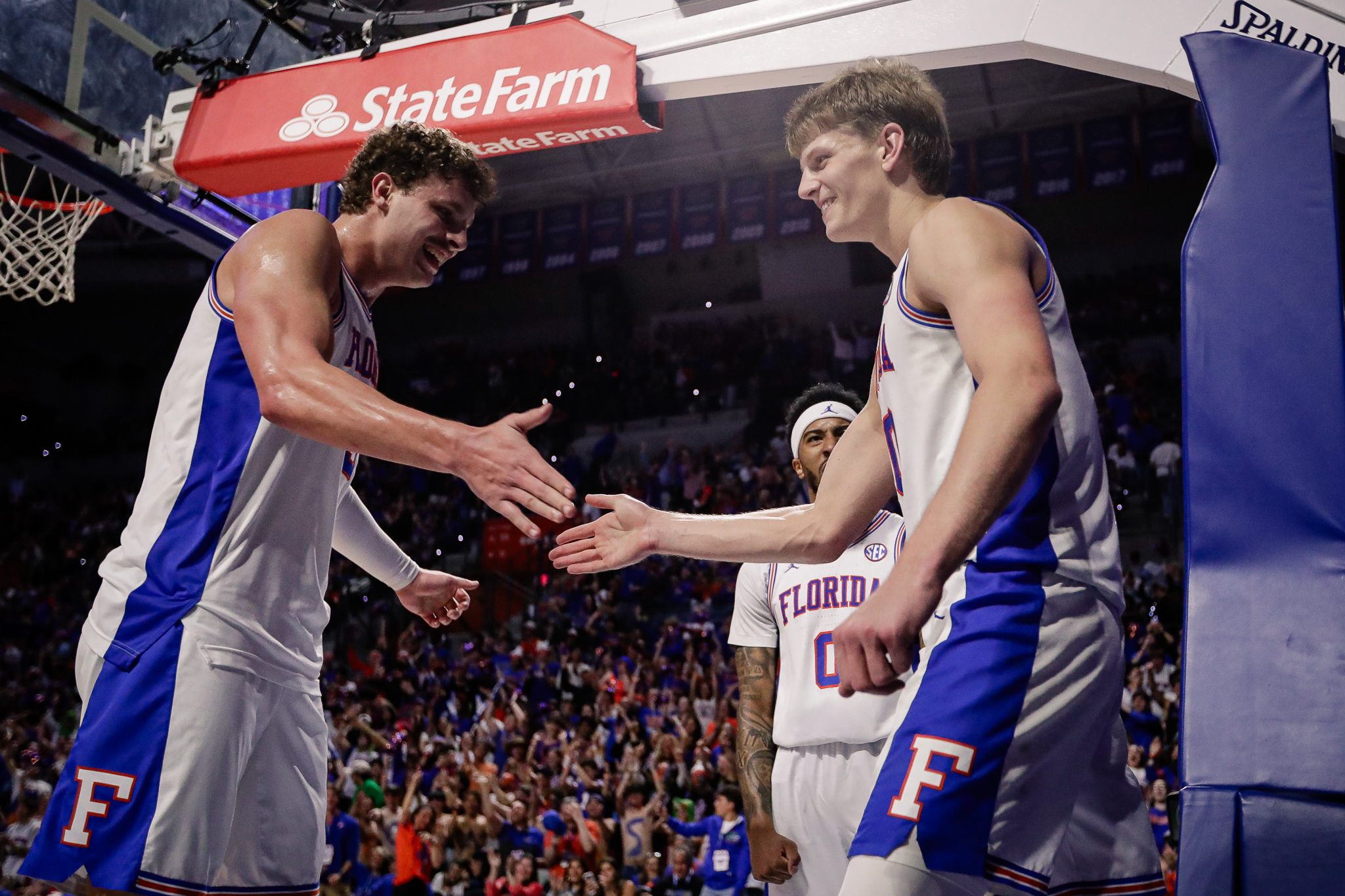 Florida Gators forward Thomas Haugh (10), featured in our Prairie View A&M vs. Florida prediction, celebrates a made basket with teammates at Exactech Arena.