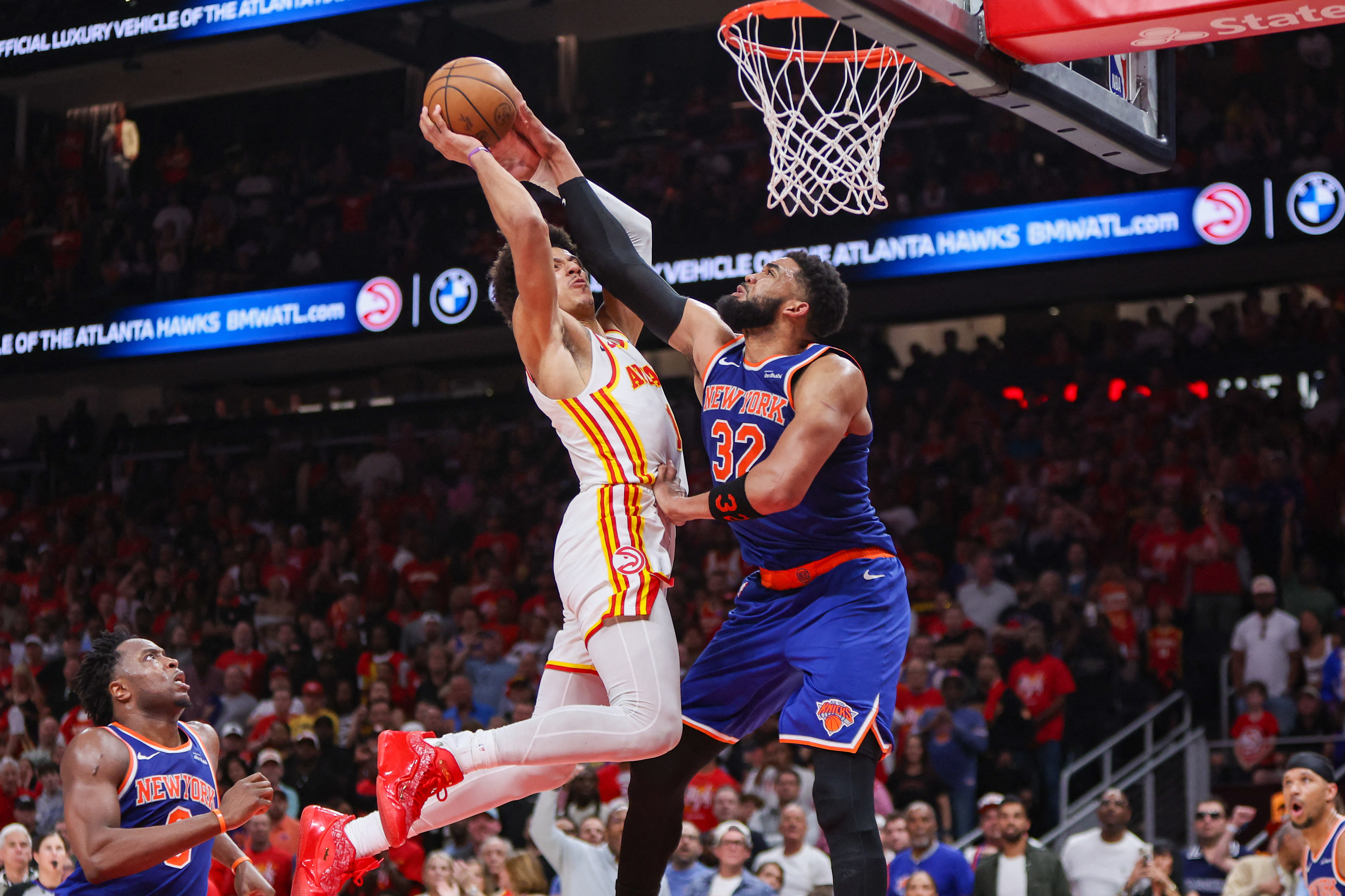 Atlanta Hawks forward Jalen Johnson (1) is defended by New York Knicks center Karl-Anthony Towns (32) as we offer our Knicks vs. Hawks Game 4 player props.
