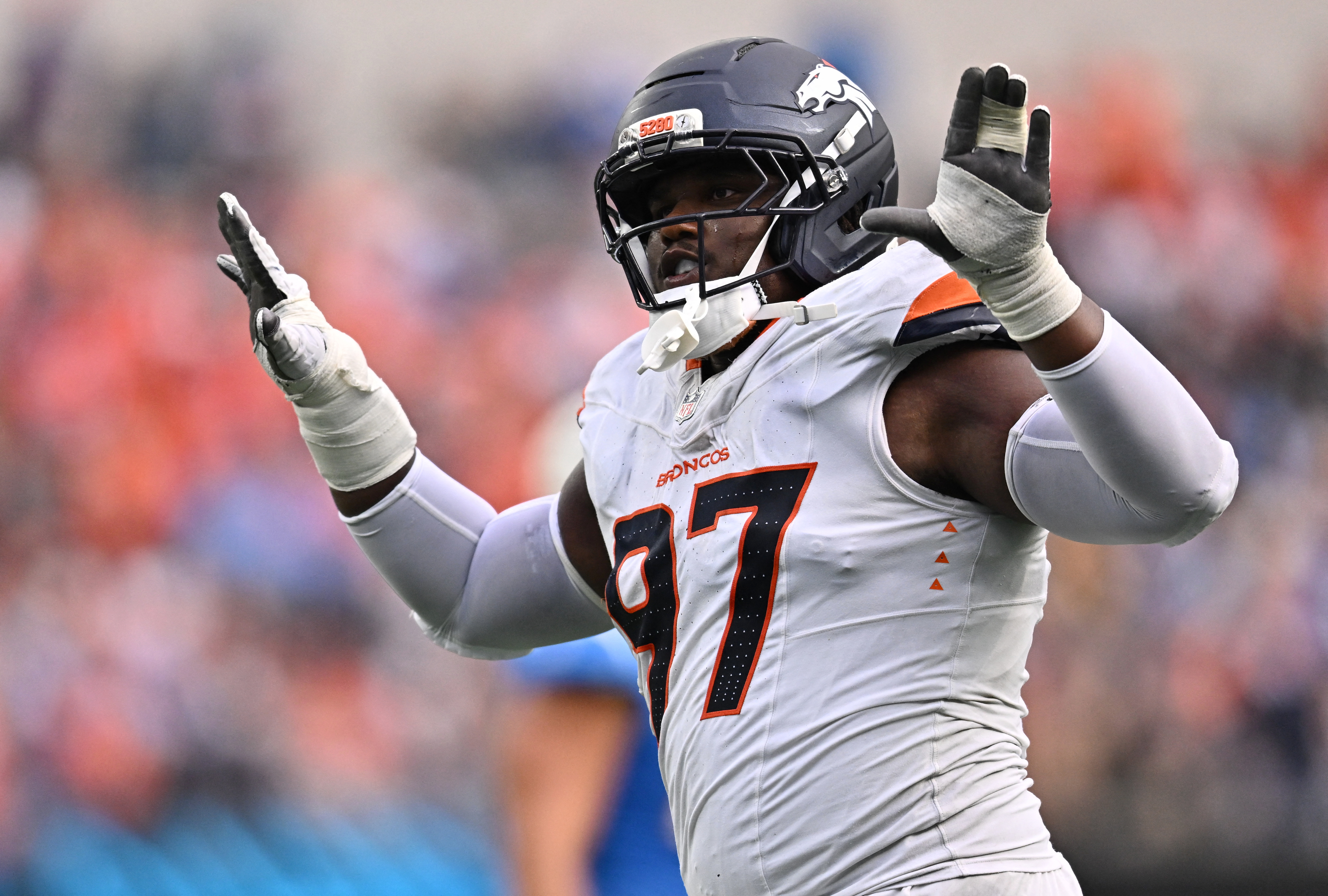Denver Broncos defensive tackle Malcolm Roach celebrates as we make our best Seahawks vs. Broncos expert picks