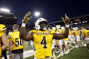Running back Harrison Waylee of the Wyoming Cowboys celebrates as we look at Fanatic Sportsbooks launch in the state.