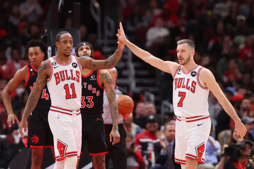 DeMar DeRozan and Goran Dragic of the Chicago Bulls celebrate a basket against the Toronto Raptors during the first half at United Center.