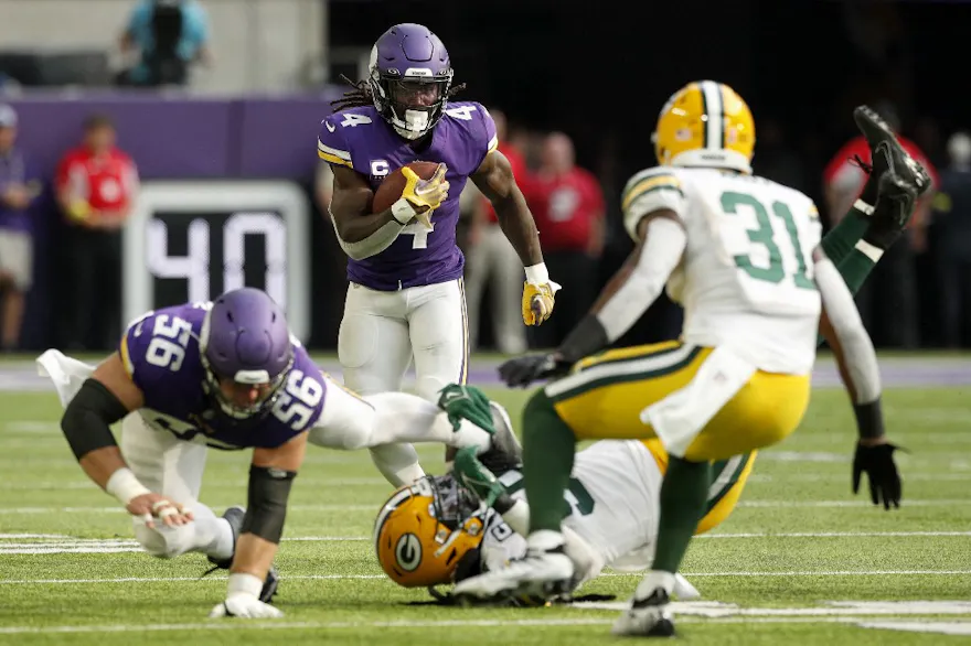 Dalvin Cook of the Minnesota Vikings runs with the ball after catching a pass during the second quarter in the game against the Green Bay Packers at U.S. Bank Stadium on September 11, 2022 in Minneapolis, Minnesota.
