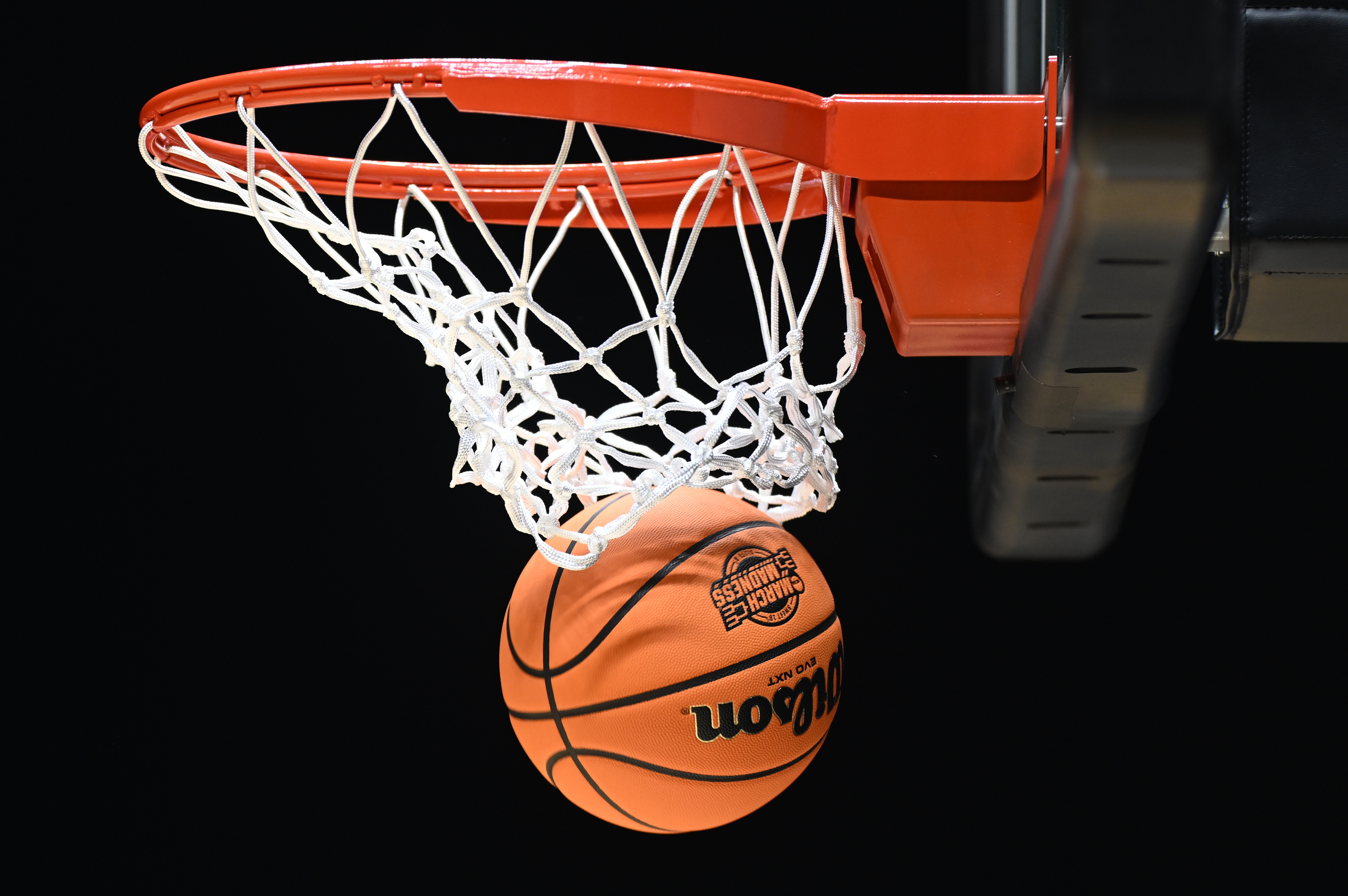 The March Madness logo is seen on a basketball as we look at March Madness bracket deadlines