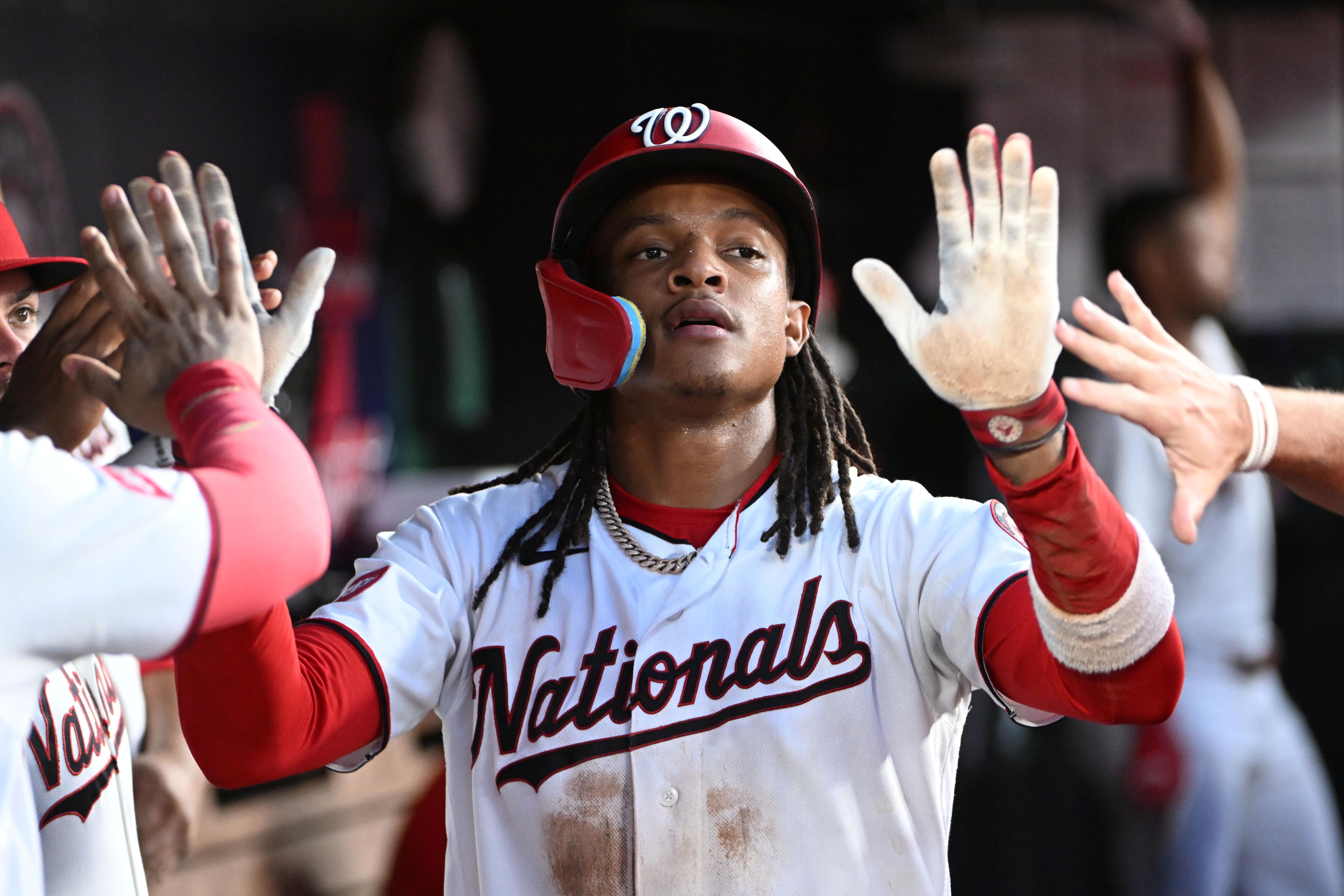 Washington Nationals shortstop CJ Abrams is congratulated by teammates after scoring a run, and he's featured in my home run predictions today.