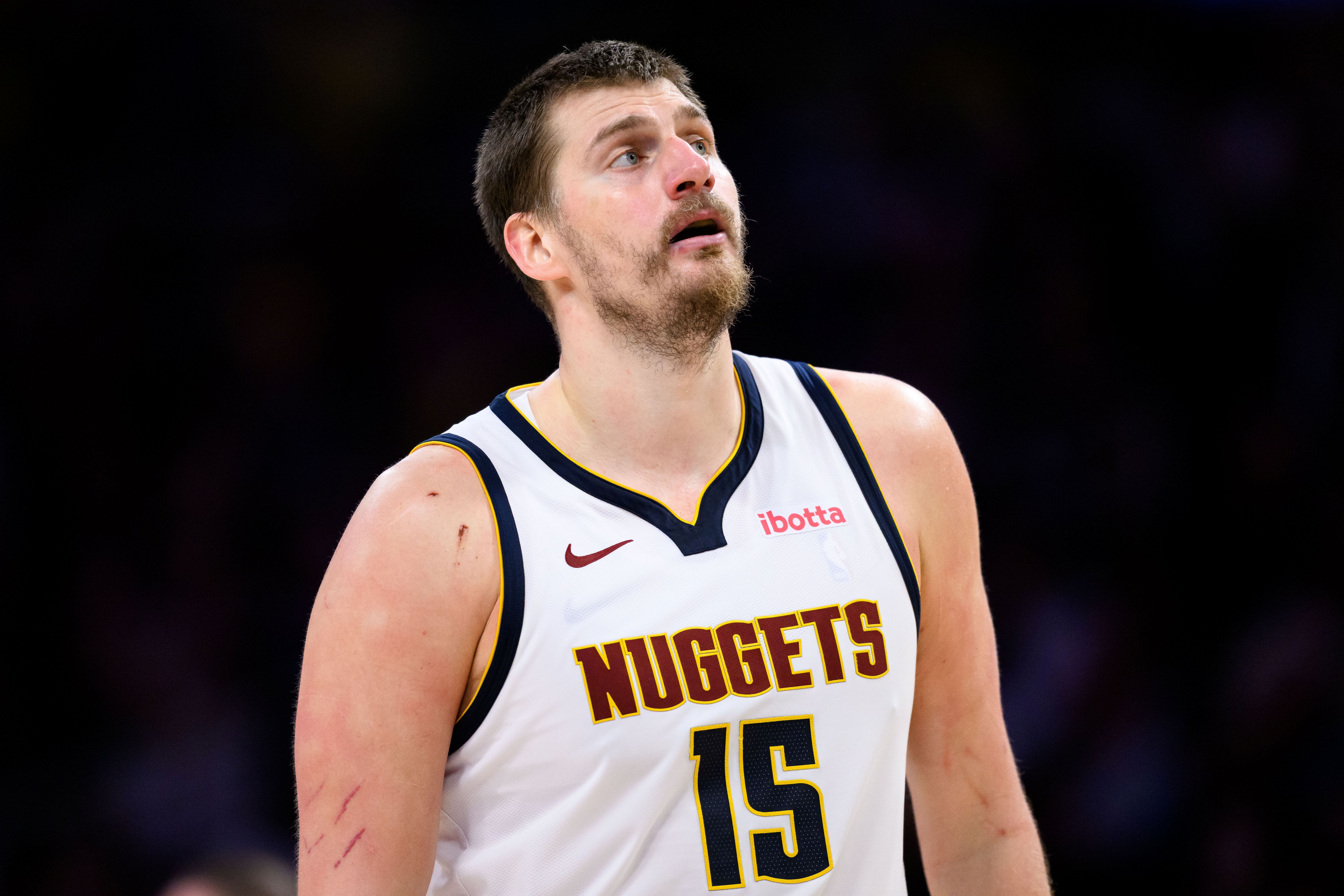 Denver Nuggets center Nikola Jokic (15), seen here looking on during a game, is featured in our 76ers vs. Nuggets player props today.