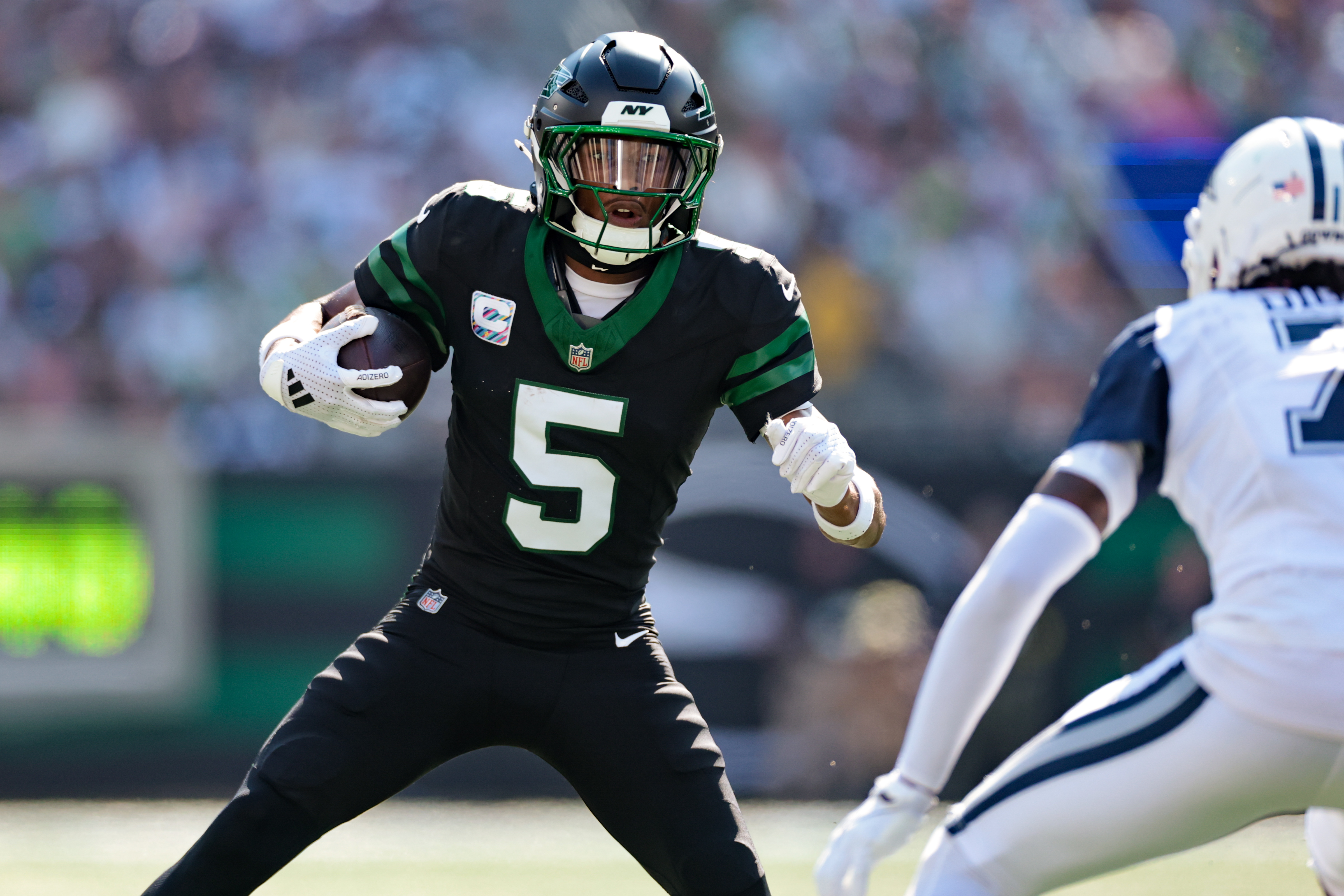 New York Jets wide receiver Garrett Wilson jukes as we make our best NFL Upset picks and predictions for Week 1.
