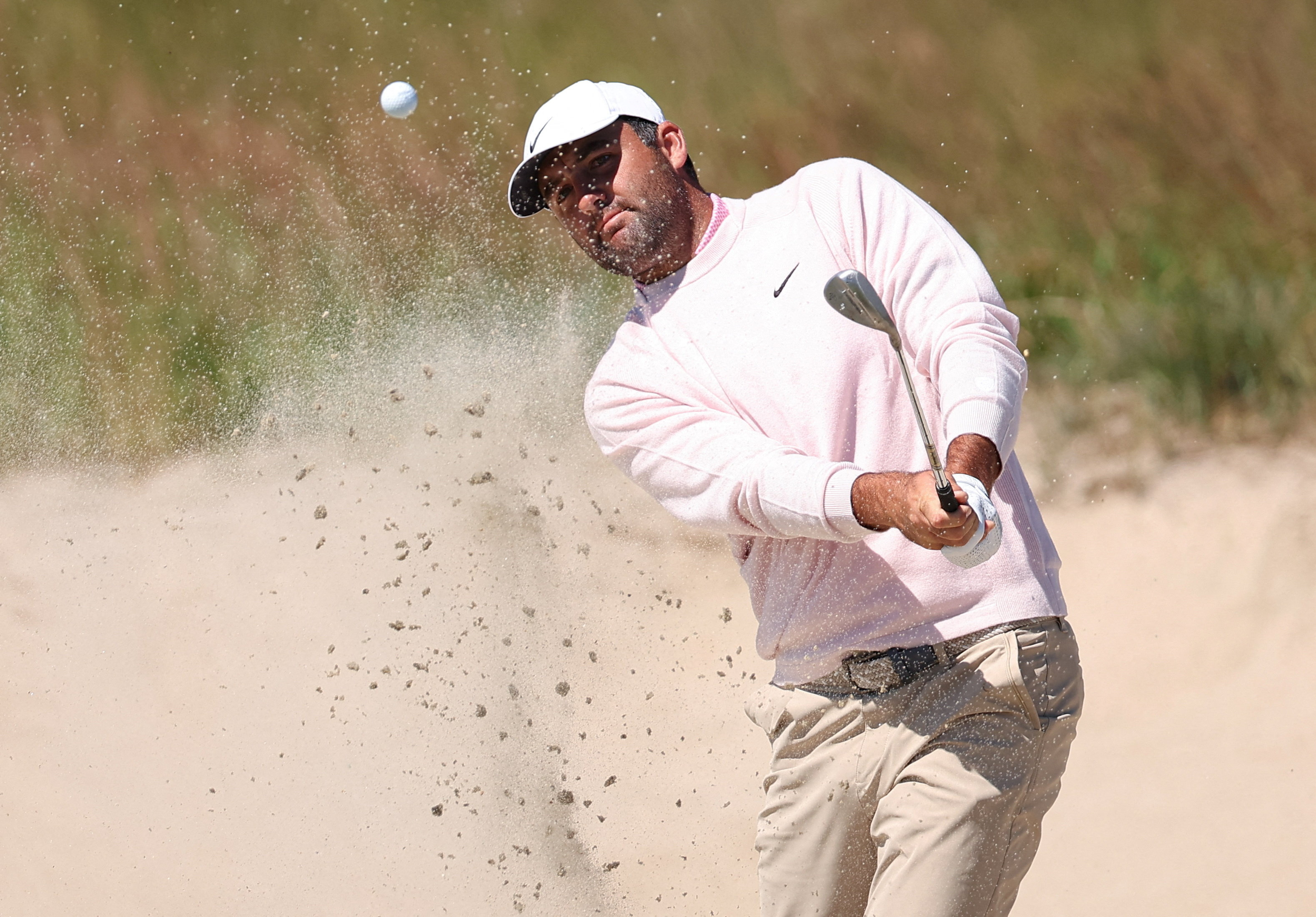 Scottie Scheffler - who's featured in the U.S. Open odds - plays a bunker shot on the second hole during a practice round for the U.S. Open golf tournament. 