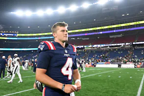 New England Patriots quarterback Bailey Zappe walks off of the field as we look at Massachusetts' sports betting financials for July 2024