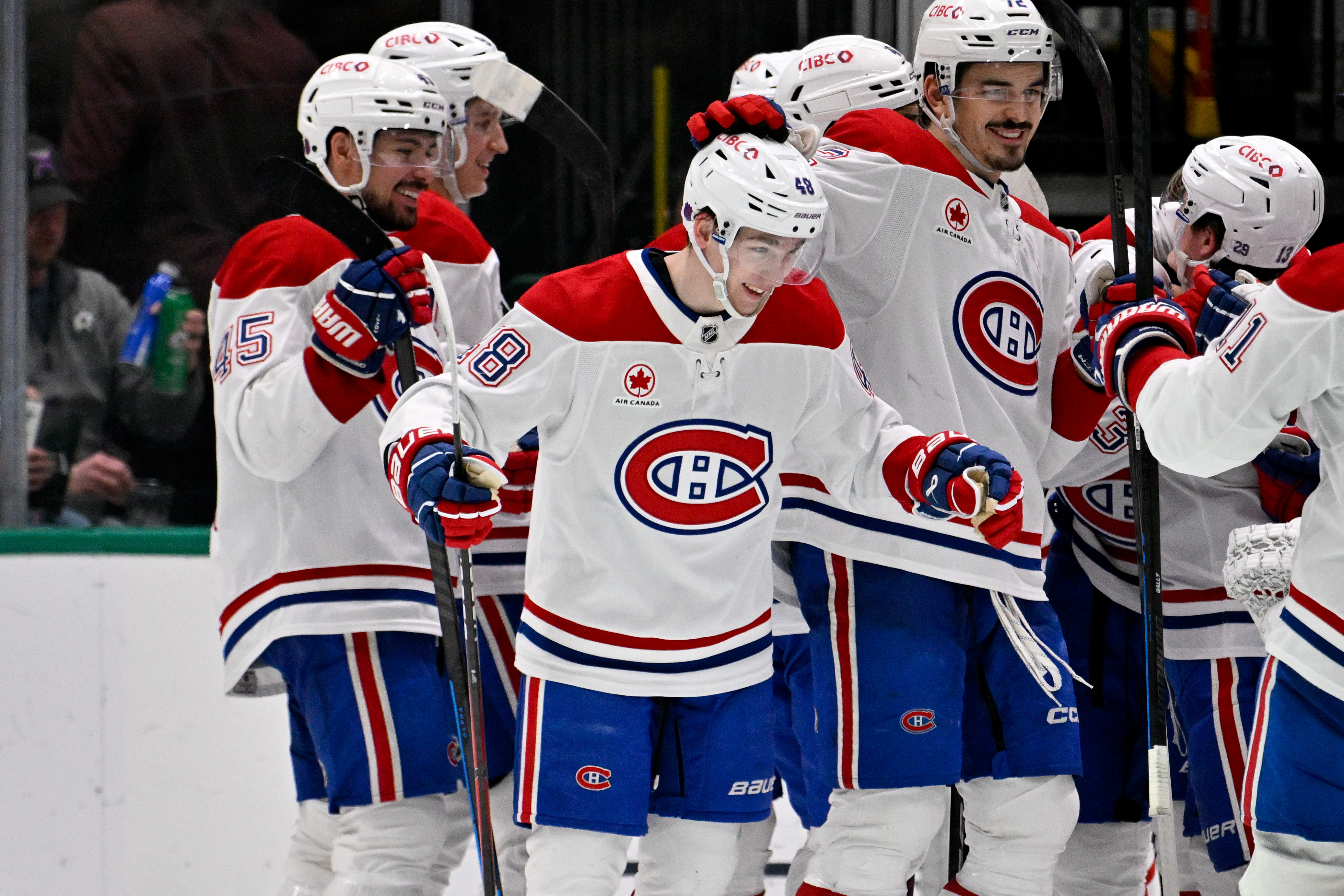Montreal Canadiens defenseman Lane Hutson (48), seen here celebrating with teammates, is featured in our NHL player props today.