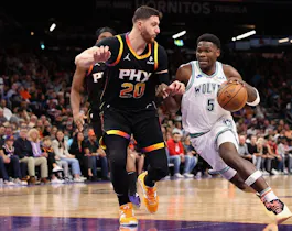 Anthony Edwards #5 of the Minnesota Timberwolves drives the ball past Jusuf Nurkic #20 of the Phoenix Suns as we offer our Suns vs. Timberwolves NBA player props and predictions for Game 1 on Saturday.