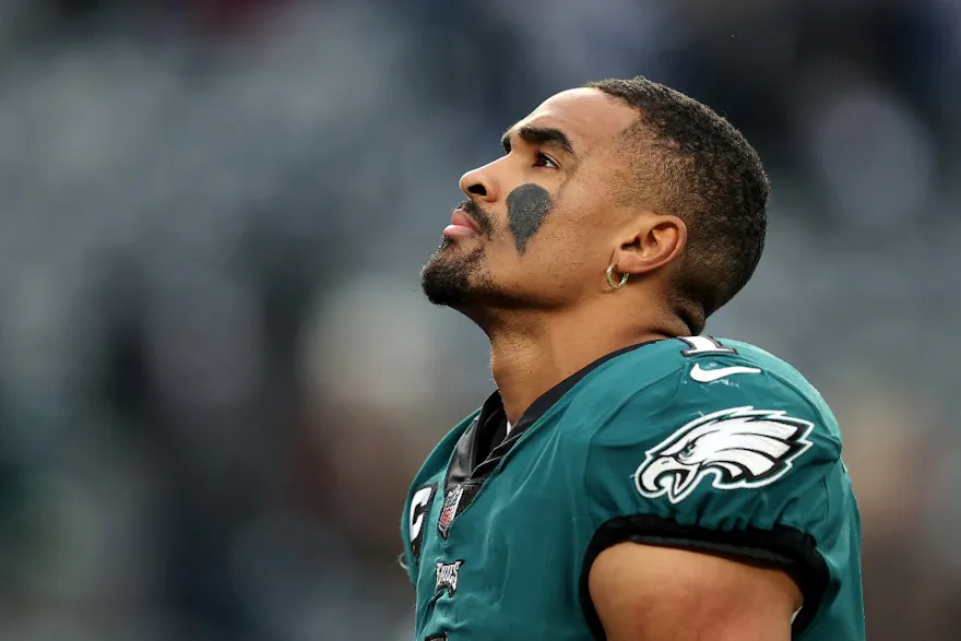 Jalen Hurts of the Philadelphia Eagles looks on as he walks off the field after his team's loss against the New York Giants, and we offer our top predictions for Vikings vs. Eagles based on the best NFL odds.