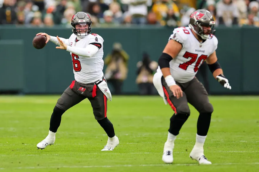 Baker Mayfield of the Tampa Bay Buccaneers drops back to pass as we share our best Buccaneers vs. Lions prediction.