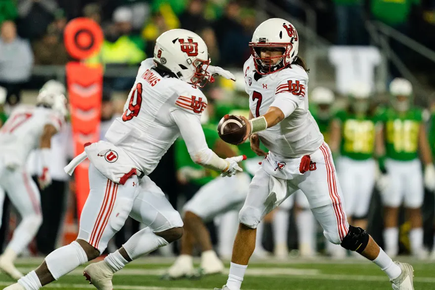  Quarterback Cameron Rising #7 of the Utah Utes hands off the ball to running back Tavion Thomas #9 during the second quarter of the game against the Oregon Ducks at Autzen Stadium on Nov. 19. 