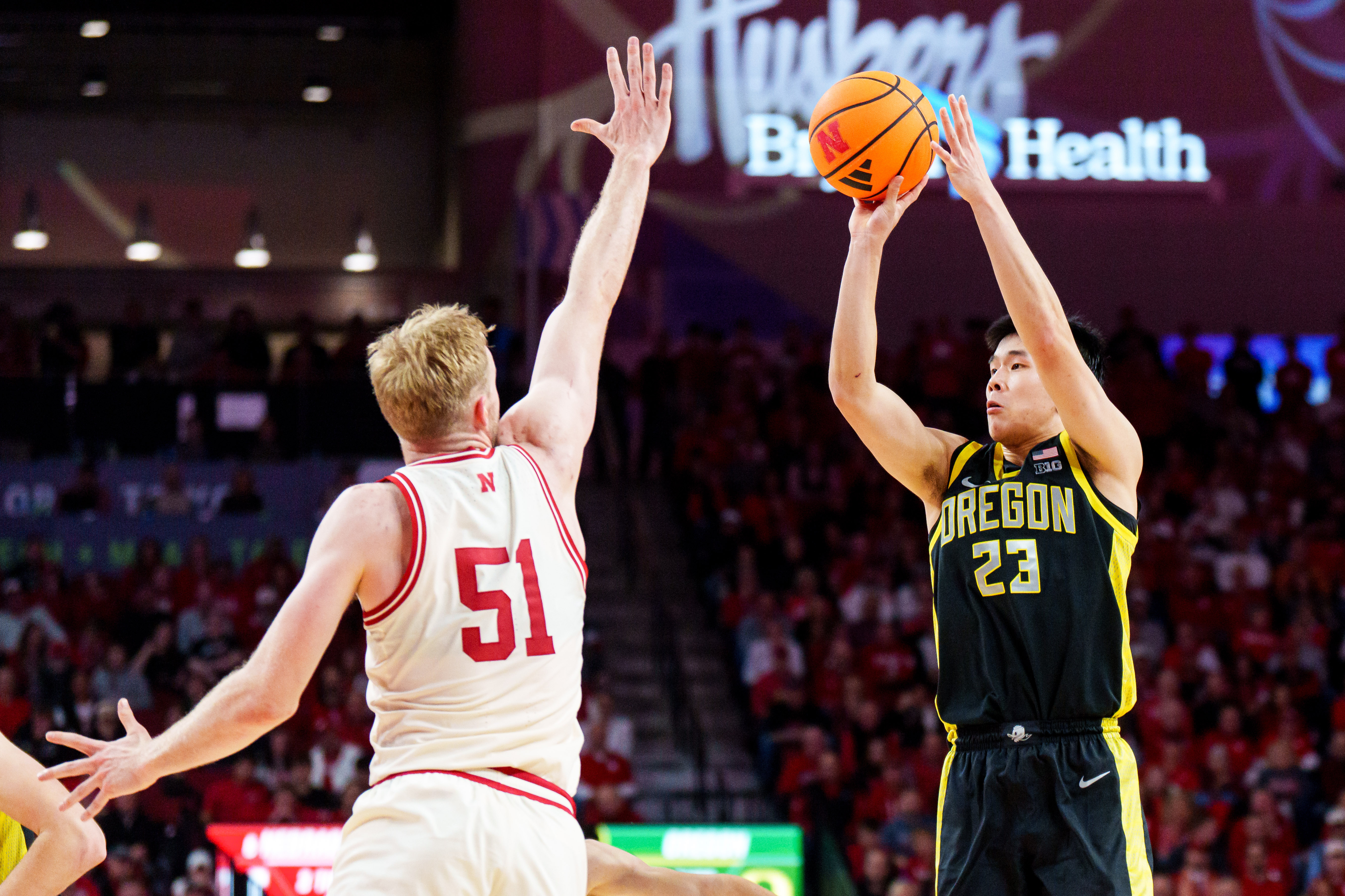 Oregon Ducks guard Wei Lin - who's featured in my College Basketball player props today - shoots against Nebraska Cornhuskers forward Rienk Mast (51) during the second half at Pinnacle Bank Arena. 