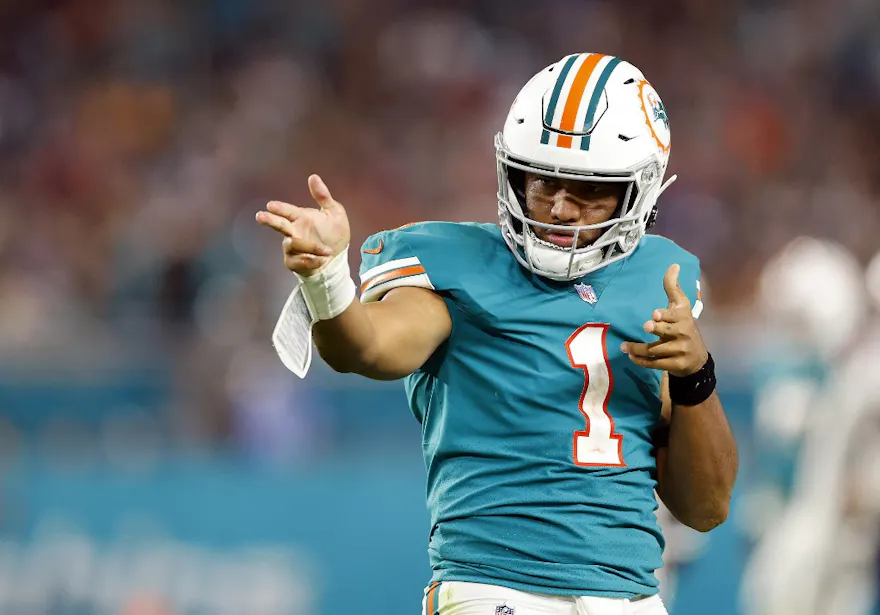 Tua Tagovailoa of the Miami Dolphins celebrates a first down in the fourth quarter against the New England Patriots, and we offer our top Dolphins vs. Jets predictions for Black Friday.